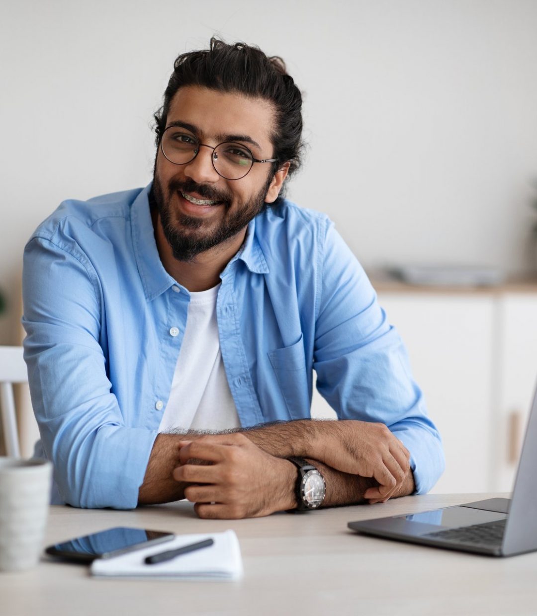 freelance-career-handsome-indian-guy-sitting-at-la-7GSJQSC.jpg