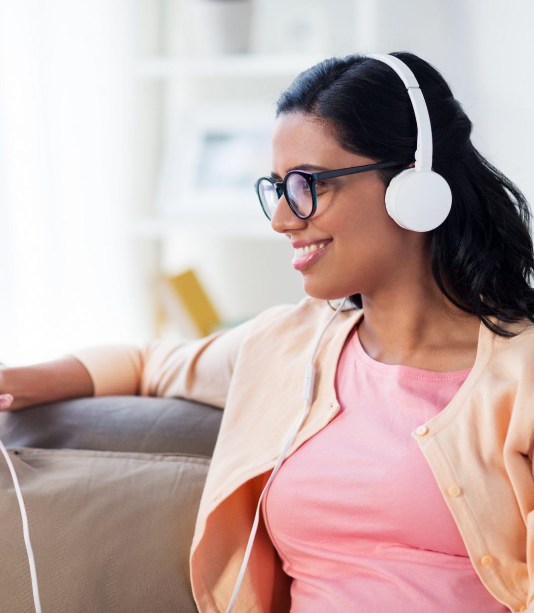 happy-woman-with-tablet-pc-and-headphones-at-home-P32QZJA-1.jpg